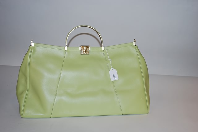 Appraisal: Barry Kieselstein-Cord large green leather handbag with top signature mask