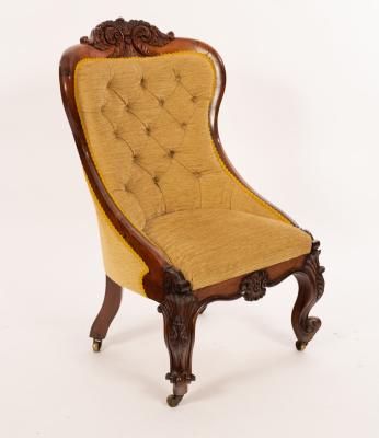 Appraisal: An early Victorian rosewood nursing chair with carved cresting rail