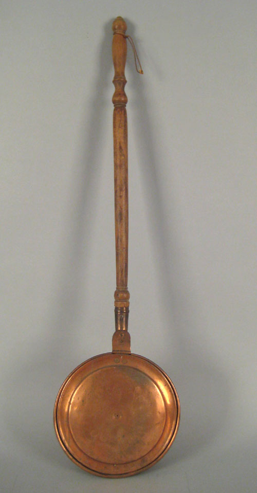 Appraisal: Engraved copper bedwarmer early th c with a turned wood