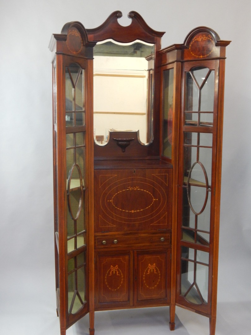 Appraisal: An Edwardian mahogany and satinwood inlaid breakfront display cabinet the