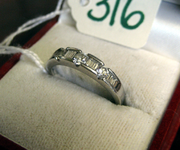 Appraisal: DIAMOND AND PLATINUM RING the narrow band set with three