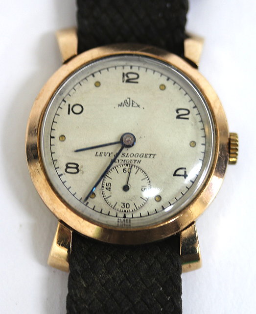 Appraisal: A MAJEX GOLD WRIST WATCH the silvered dial with Arabic