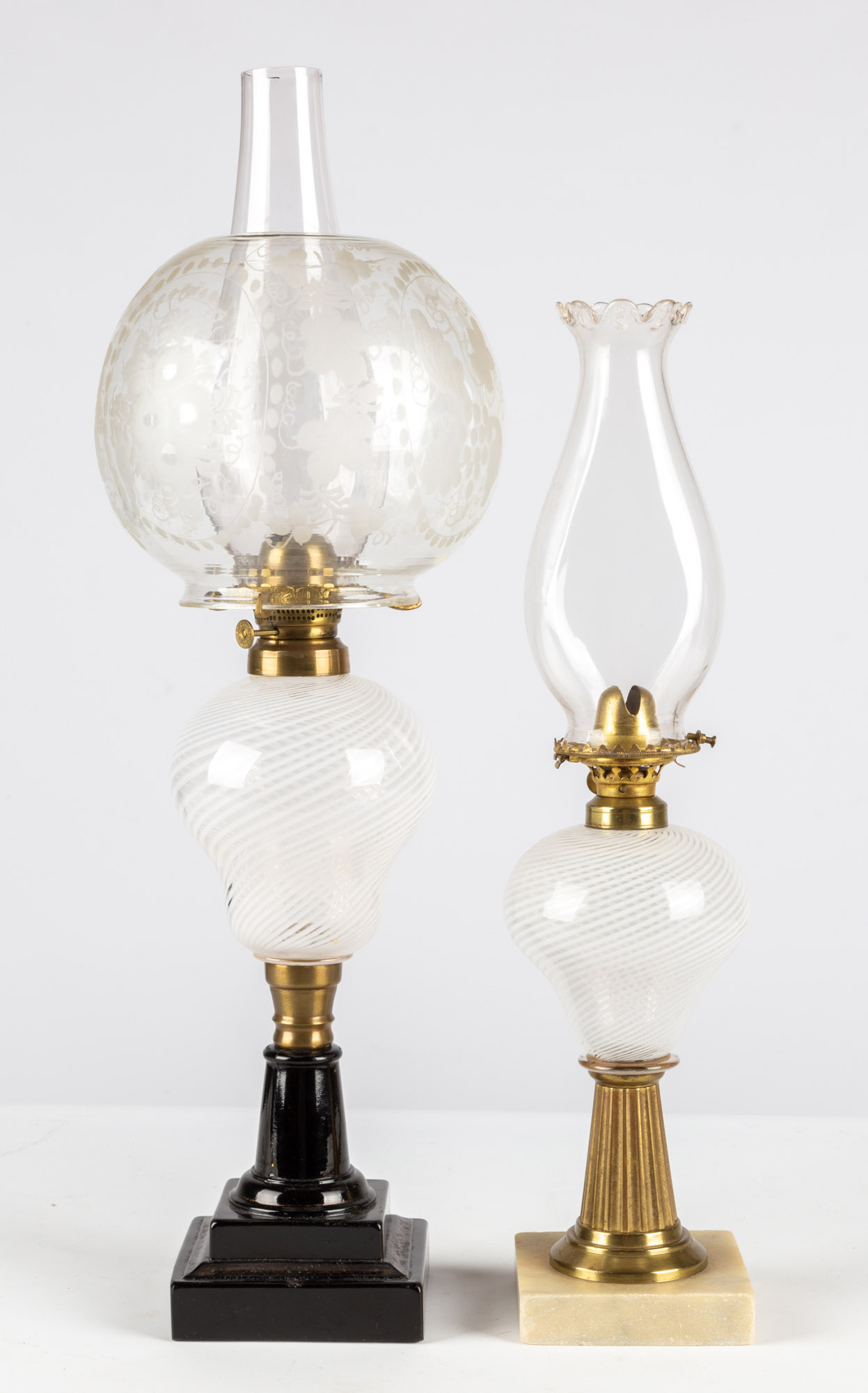 Appraisal: WHITE THREADED OIL LAMPS circa clear glass with white swirled