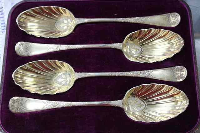 Appraisal: A CASED SET OF FOUR GILT SERVING SPOONS with shell