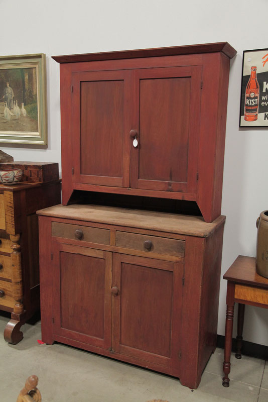 Appraisal: TWO PIECE WALL CUPBOARD Red stained cupboard having paneled doors