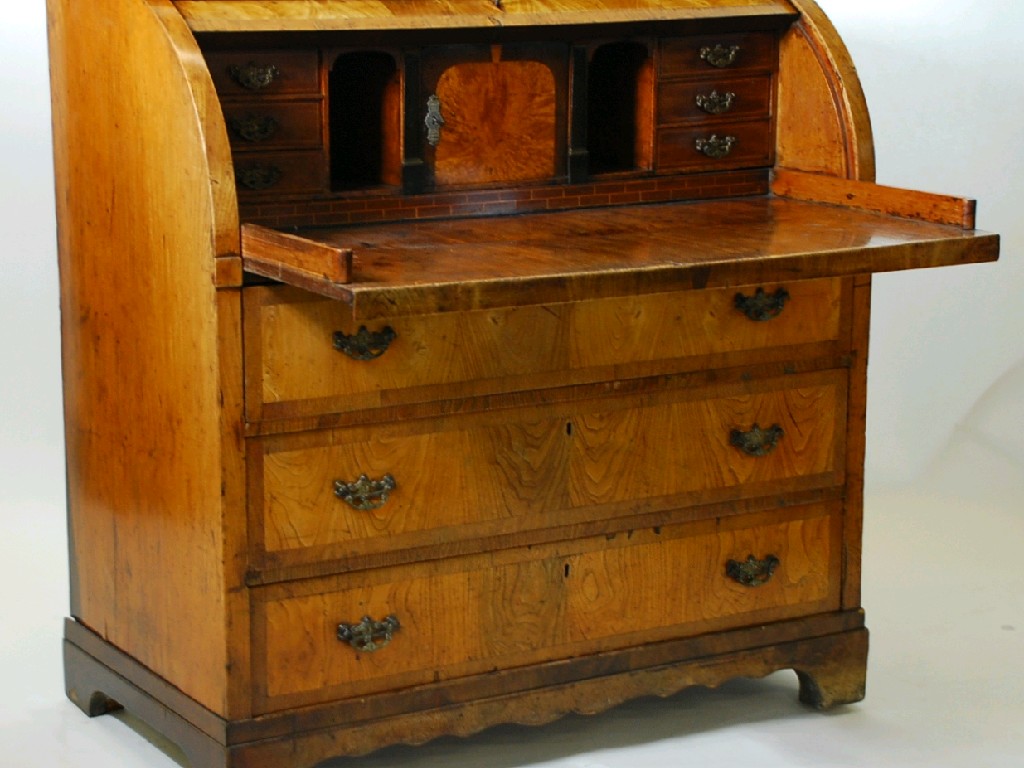 Appraisal: CONTINENTAL ANTIQUE CROSSBANDED YEWWOOD CYLINDRICAL BUREAU the plain oblong top