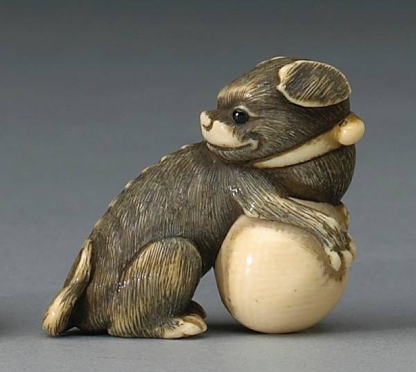 Appraisal: An ivory study of a pup and ball Osaka Early