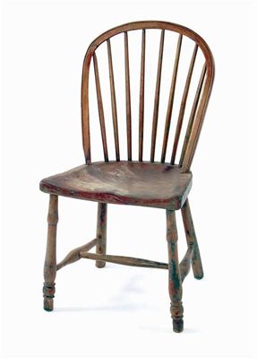 Appraisal: A th century fruitwood and elm seated Windsor armchair with