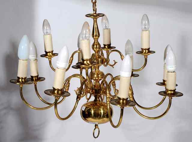 Appraisal: A DUTCH STYLE BRASS TWELVE LIGHT ELECTROLIER with scrolling branches