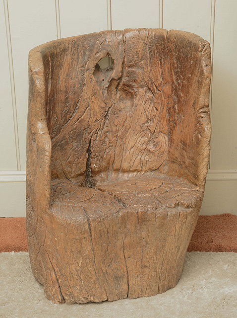 Appraisal: A RUSTIC CARVED SEAT formed from a tree trunk wide