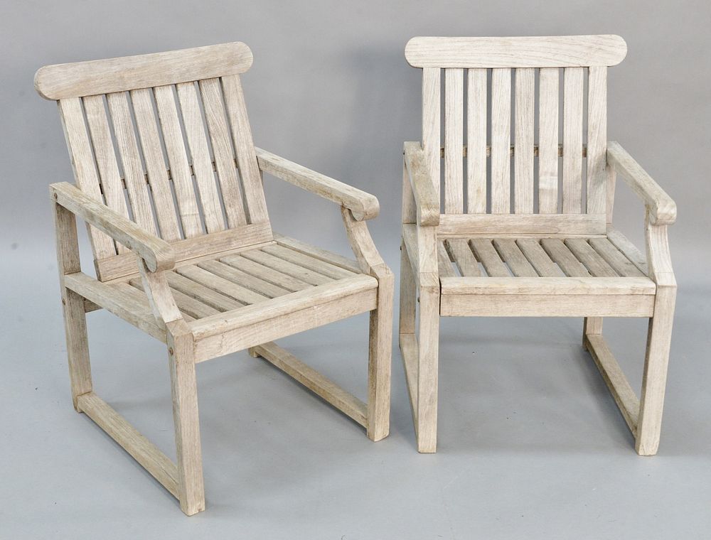 Appraisal: Pair of teak outdoor armchairs Pair of teak outdoor armchairs