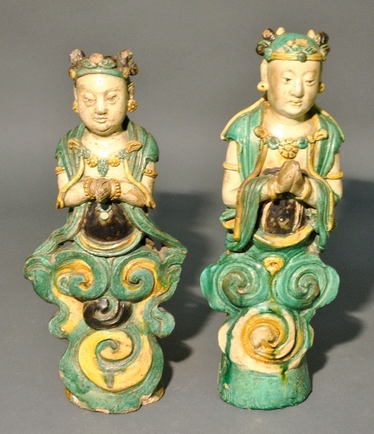 Appraisal: - Two glazed earthenware Asian deities with praying hands th