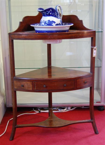 Appraisal: A Georgian mahogany corner washstand the shaped gallery over three