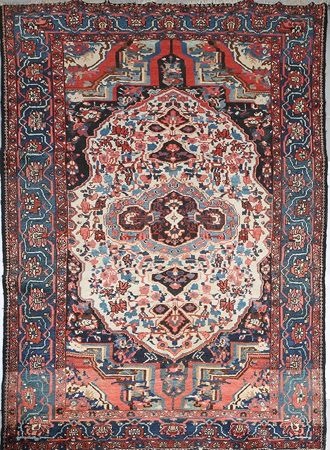 Appraisal: A BAKTIARI RED GROUND RUG with a central large white