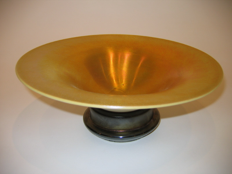 Appraisal: STEUBEN Gold iridescent and calcite glass bowl resting on glass