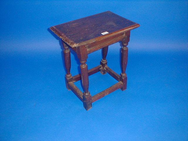 Appraisal: A Jacobean style oak joined stool with inset panel frieze