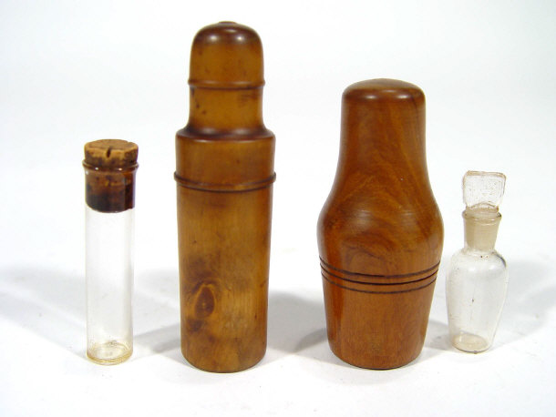 Appraisal: Two glass poison bottles in turned fruit wood cases the