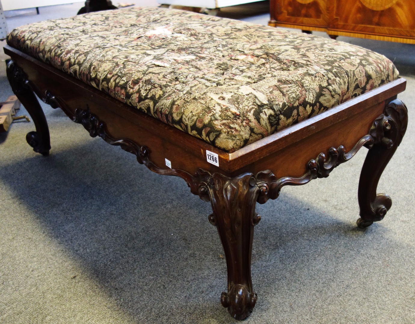 Appraisal: A Victorian carved mahogany rectangular lift top stool on scroll