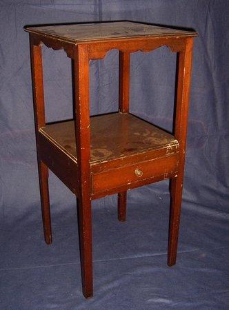 Appraisal: A mahogany bedside table fitted a drawer on square chamfered