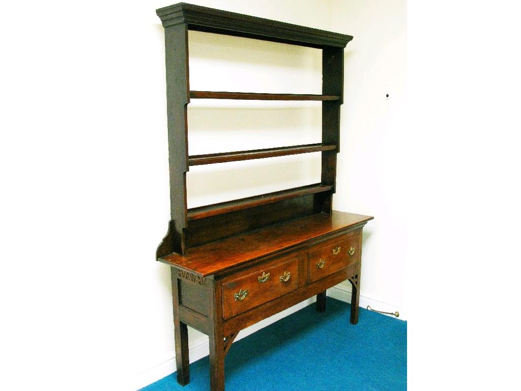 Appraisal: An oak Dresser with plate rack two frieze drawers on