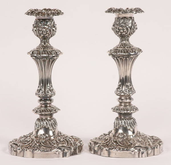 Appraisal: A pair of English sterling silver repousse candlesticks with the