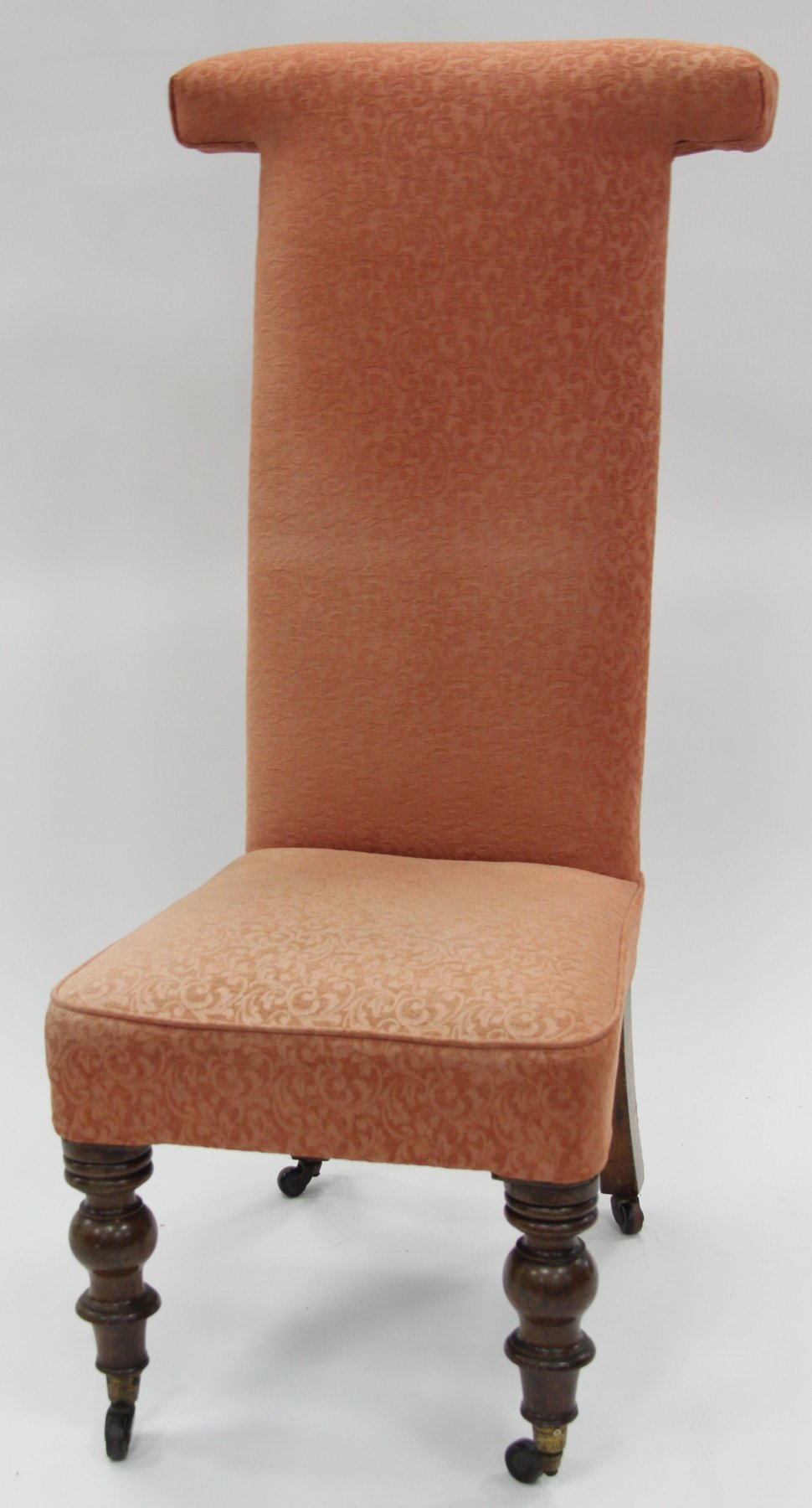 Appraisal: An upholstered prie dieu chair with T shaped back on