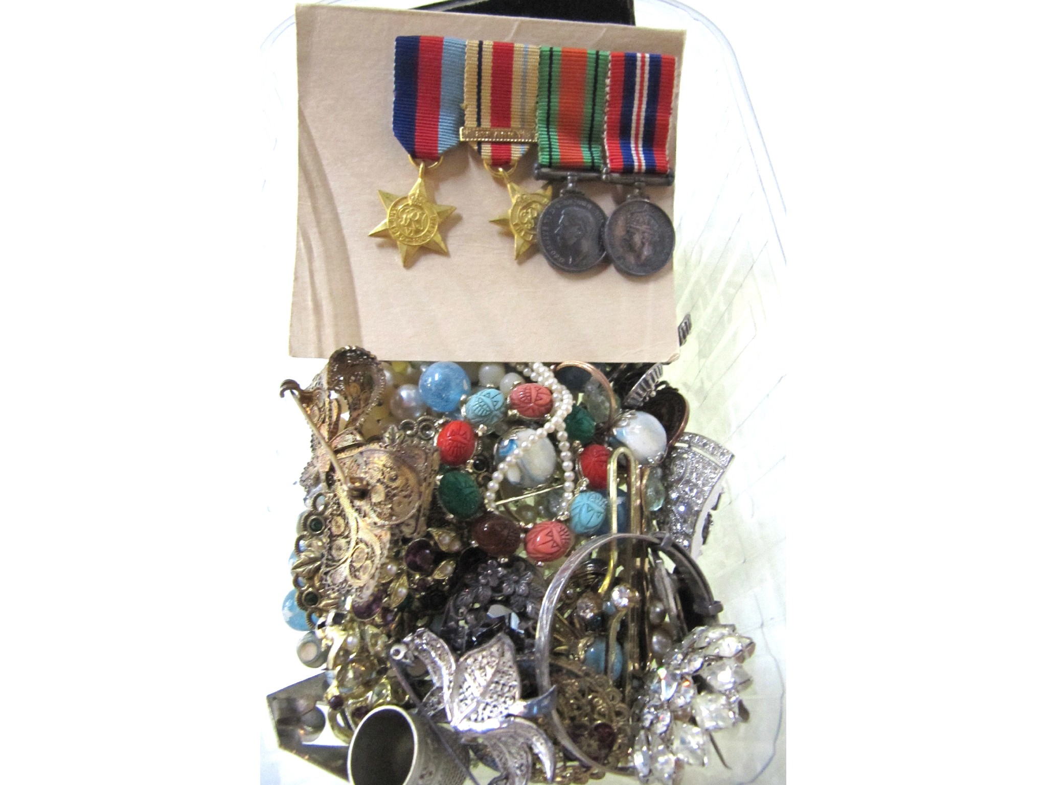 Appraisal: A box of costume jewellery miniature medal etc