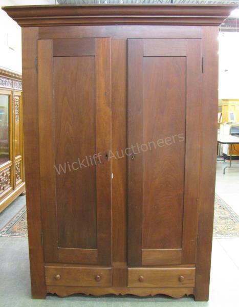 Appraisal: A mid th century American walnut armoire raised panel blind