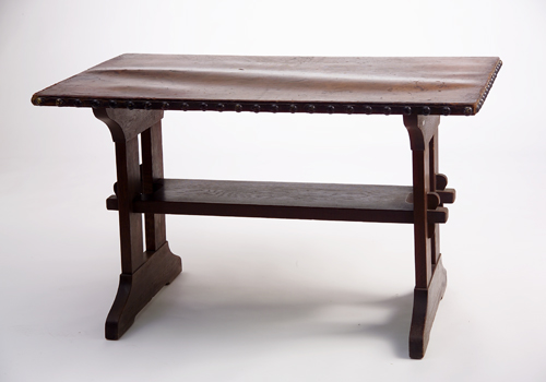 Appraisal: GUSTAV STICKLEY Trestle table with tacked-on leather top and lower