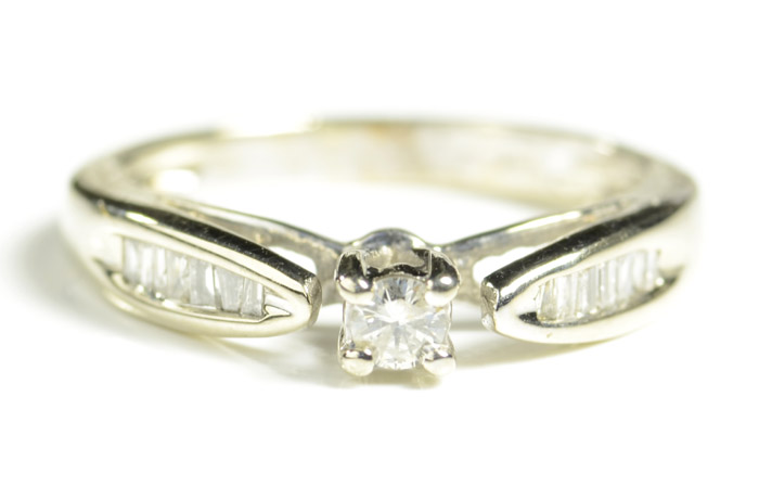 Appraisal: DIAMOND AND FOURTEEN KARAT WHITE GOLD RING with channel set