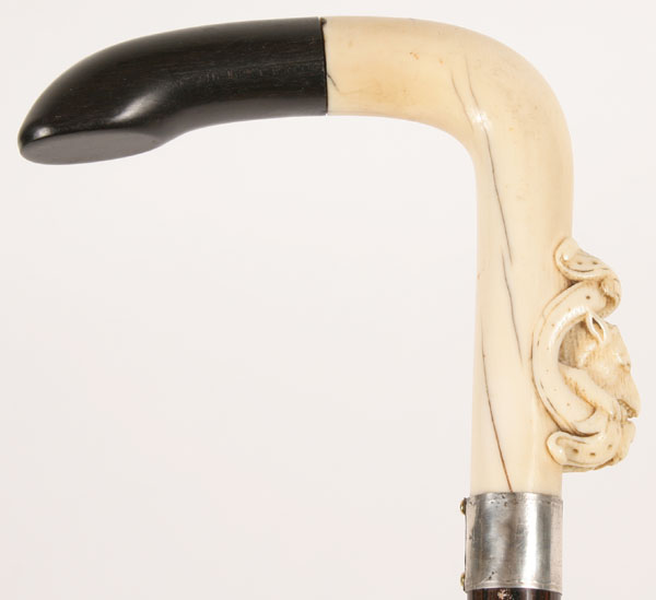 Appraisal: Cane with finely carved ivory handle depicting a wolf with