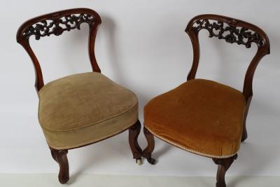 Appraisal: A pair of Victorian walnut nursing chairs one with brass