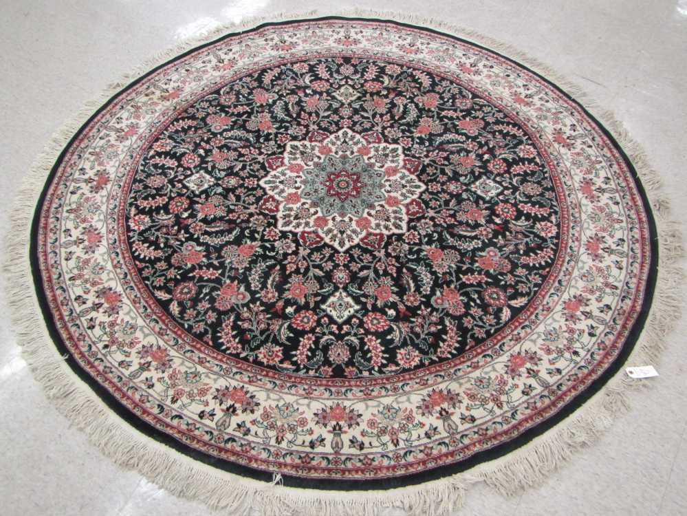 Appraisal: A ROUND ORIENTAL AREA RUG Indo-Persian floral and central floral