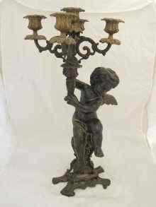 Appraisal: A bronze cherub holding a five light gilt candelabrum Ht