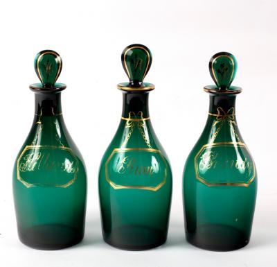 Appraisal: A set of three th Century green glass spirit decanters