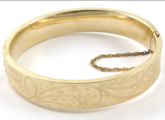 Appraisal: FOURTEEN KARAT YELLOW GOLD BANGLE The oval hinged bangle weighing