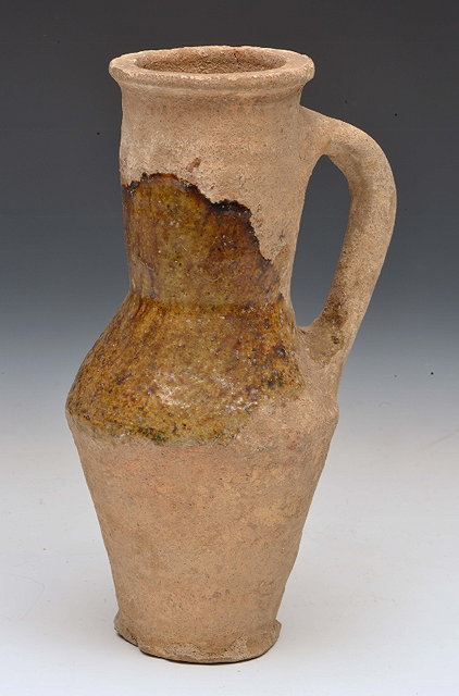 Appraisal: A MEDIEVAL ENGLISH POTTERY SIDE HANDLED EWER of tapering form