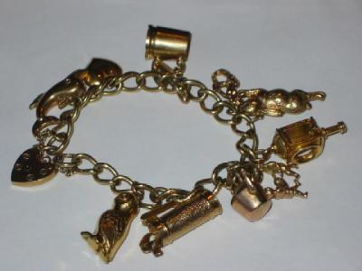 Appraisal: A CT GOLD CHARM BRACELET the curb chain hanging with