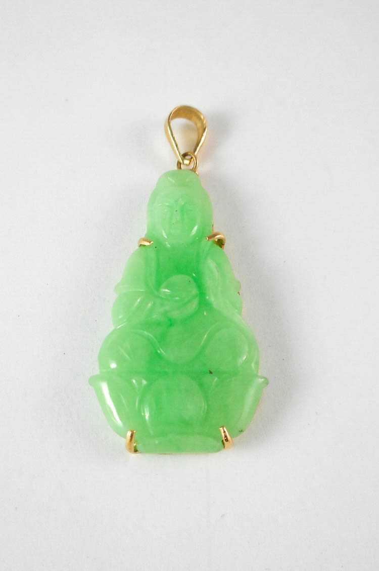 Appraisal: JADE AND FOURTEEN KARAT GOLD PENDANT The yellow gold pendant