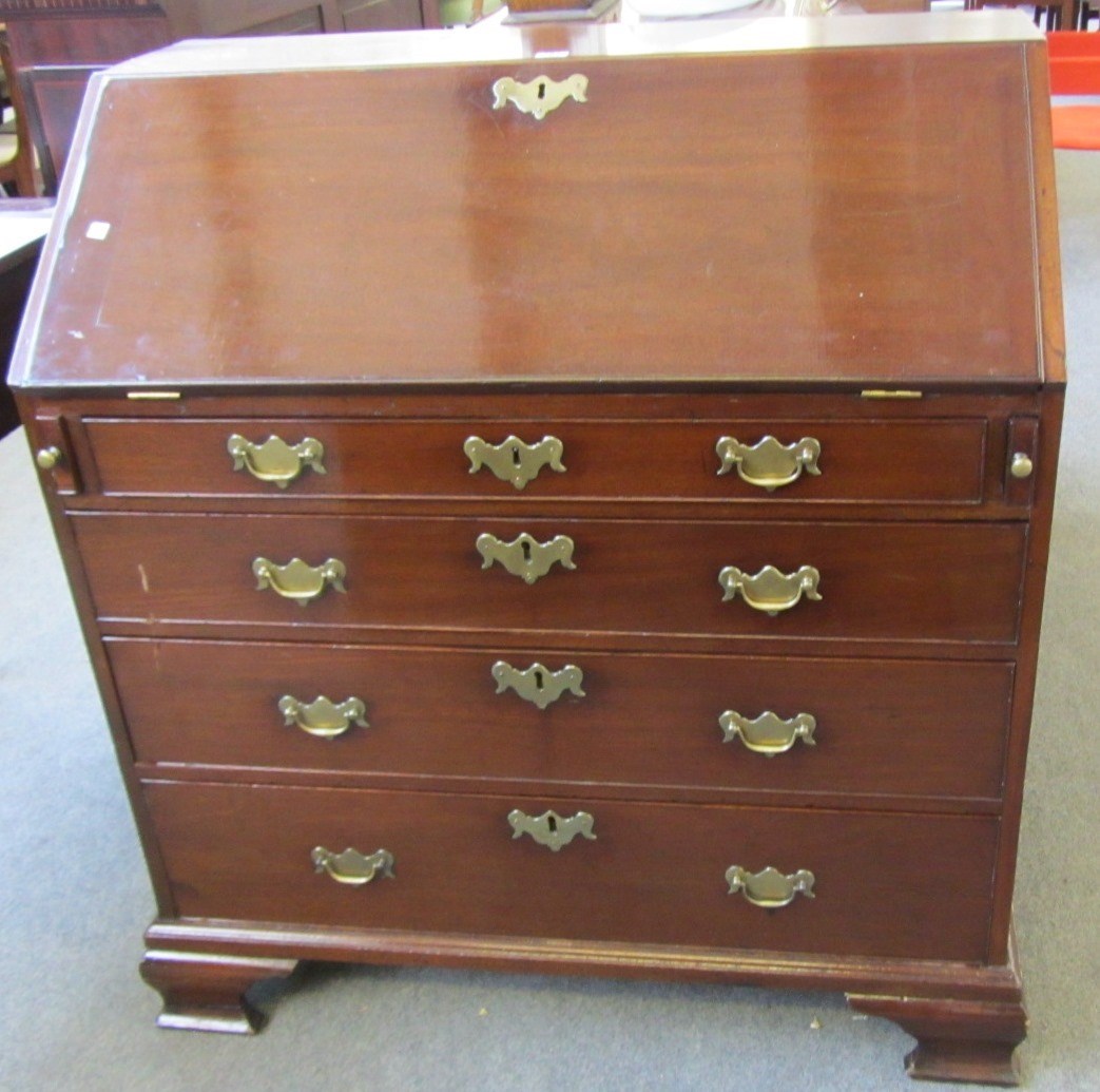 Appraisal: A mid th century mahogany bureau the fall enclosing a