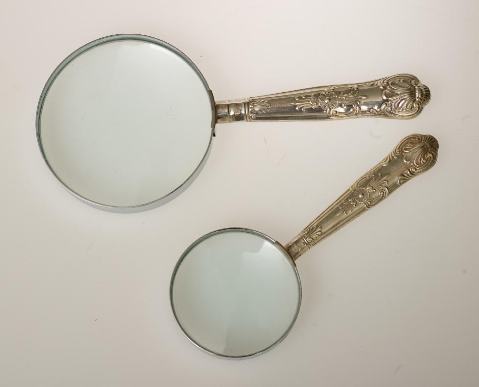 Appraisal: TWO SILVER-HANDLED MAGNIFYING GLASSES EARLY th CENTURY the handle of