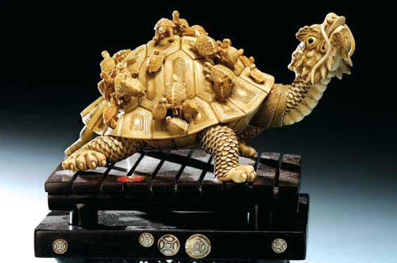 Appraisal: ELABORATE FOSSIL IVORY GROUP Elaborately carved fossil mammoth ivory group