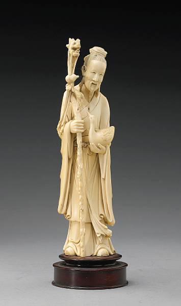 Appraisal: A tinted ivory figure of a sage th Century The