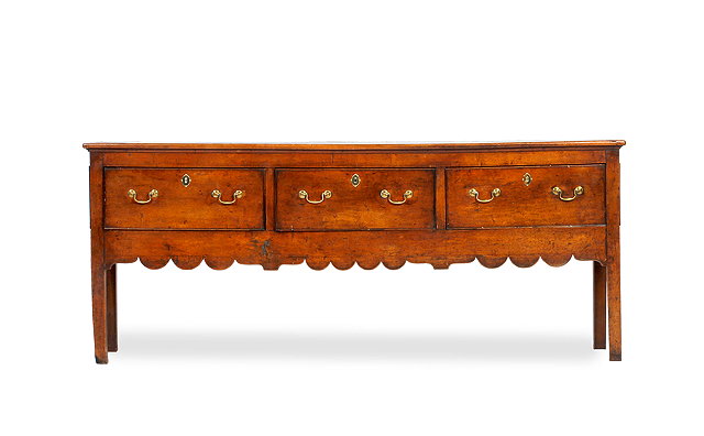 Appraisal: A GEORGE III FRUITWOOD DRESSER BASE fitted with three drawers