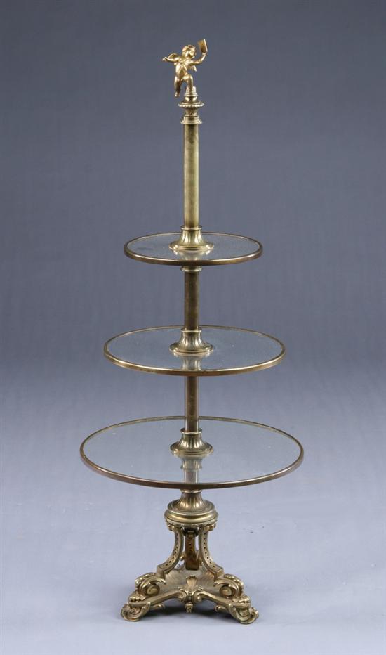 Appraisal: CONTINENTAL TRANSITIONAL THREE-TIER SERVER th century gilt-metal and glass Putto