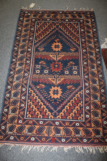 Appraisal: A PAKISTAN BLUE GROUND RUG with allover geometric decoration cm