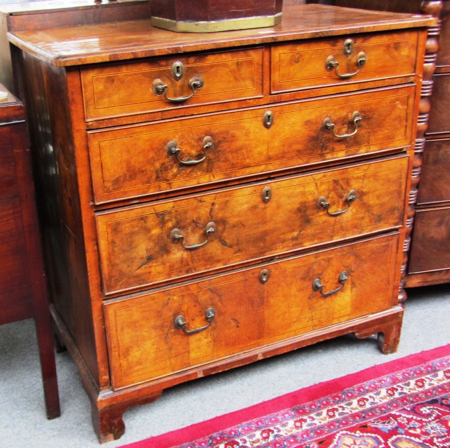 Appraisal: A mid th century figured walnut chest with two short