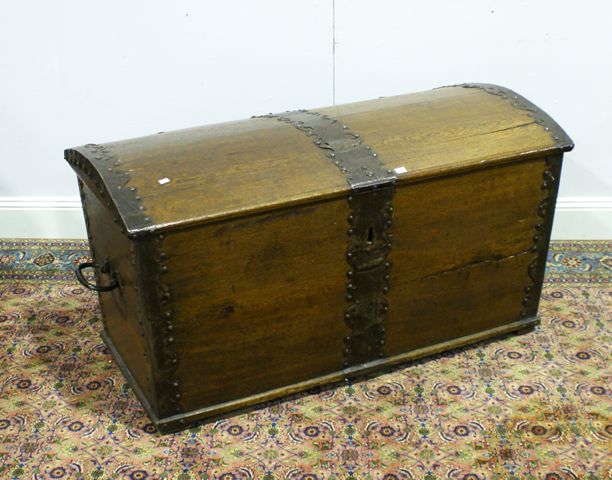 Appraisal: An oak and iron-bound domed topped chest with original lock