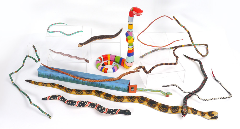 Appraisal: LOT OF CARVED PAINTED FOLK ART SNAKES An assembled collection