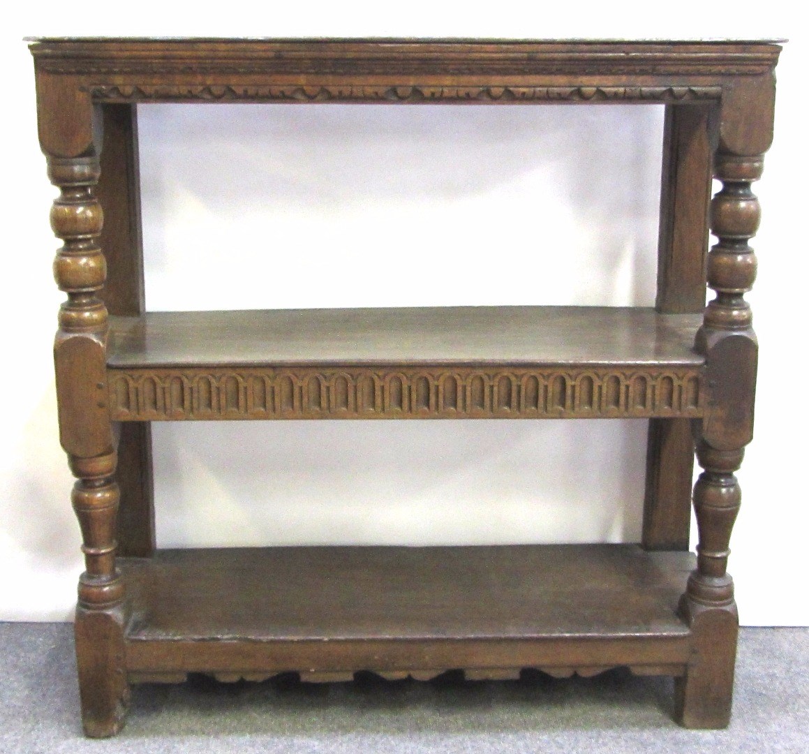 Appraisal: An th century and later carved oak three tier buffet